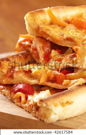 Stack of portions of pizza with cheese, pepper and chicken meat.