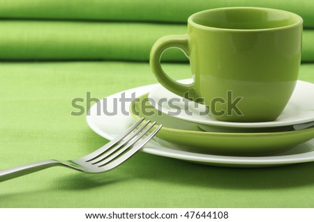 stock photo Green and white plates and cup stainless fork and knife on 