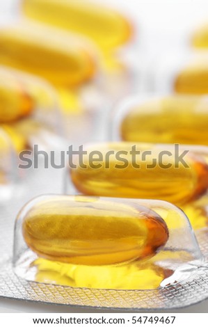 Close-up of capsules with cod liver oil in blister.