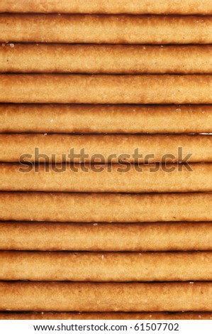 Stack of square crackers close-up, full frame.