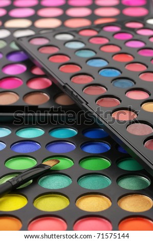 Set of various eye shadows palettes with brush.