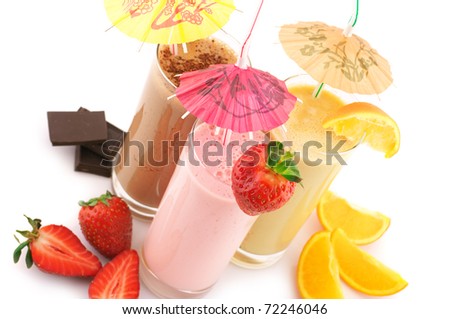 Three assorted protein cocktails with straws, decorations and fruits on white background.