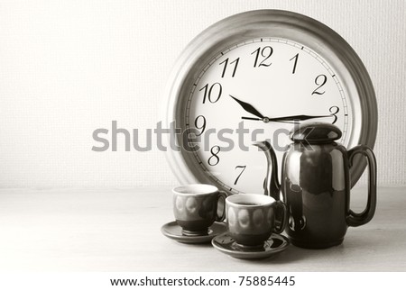 Coffee time: coffee set and clock. Sepia.