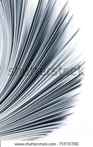 Close-up of magazine pages on white background. Toned monochrome image. Shallow DOF, focus on edges.