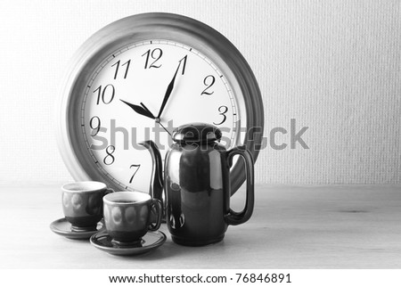 Coffee time: coffee set and clock. B&W image.