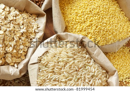Close-up of assorted cereals in paper bags.
