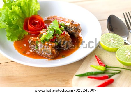Sour and Spicy Sardines in tomato sauce salad. Thai food.