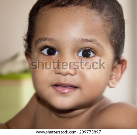 An happy and surprised kid looking surprised