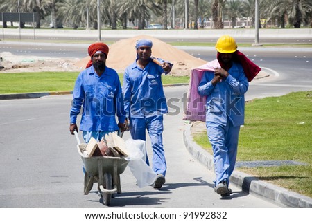 DUBAI, UAE - FEBRUARY 12: A group of construction workers in Dubai. A general image of a group of workers in their working mood in a construction site in Dubai on 12th Feb 2012.