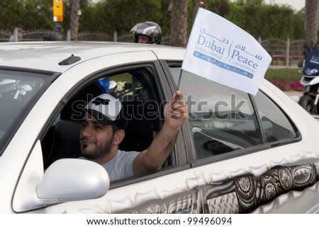 DUBAI - UAE - APRIL 06 2012: An unidentified person waving the peace flag during the \