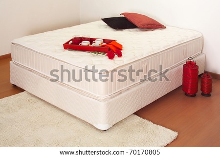 Unmade bed with breakfast tray