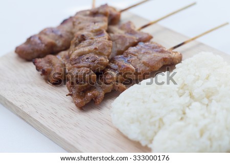 Grilled pork in asian style sticky rice that in Thailand is famous food for breakfast.(selective focus)
