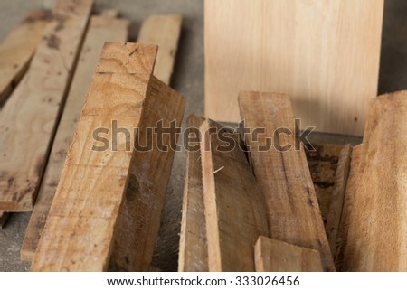 A pile of fresh wood plank that are the raw material for carpenter(soft focus)