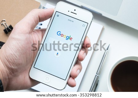 CHIANG MAI, THAILAND - DEC 19,2015: Young man is using Google search application on Apple iPhone5 smartphone.
