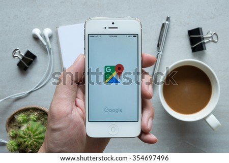 CHIANG MAI, THAILAND - DEC 20,2015: A man is using Google Maps application on Apple iPhone. Google Maps is a service that provides information about geographical regions and sites around the world.