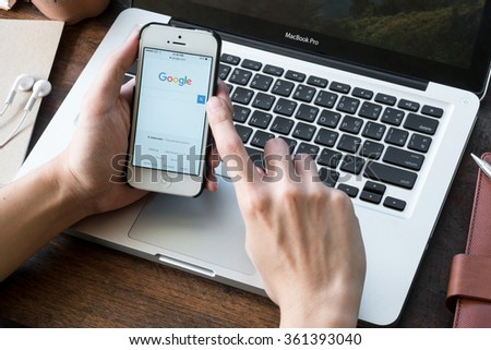 CHIANG MAI, THAILAND - JAN 10,2016: A man is using Google's search website on Apple iPhone. Google website is the search engine service provide by Google.