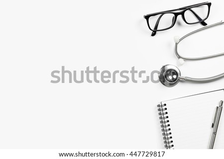 Top view of doctor desk table with stethoscope and notebook with pen. Top view with copy space, flat lay.