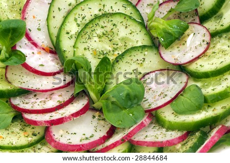 salad of fresh cucumbers and radishes with leaves Corn salad