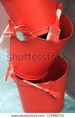 Metal buckets in red and paintbrushes