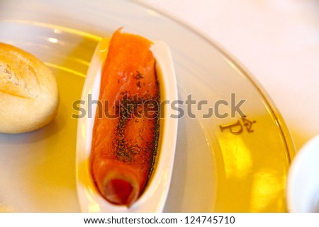 Slice of salmon  bread roll on plate State run hotel Merida Spain