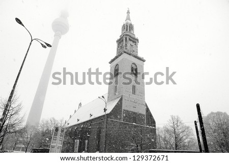 TV tower and Sta Marys church in snow Berlin Germany