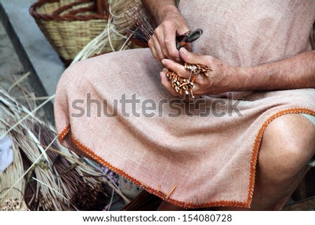 basketry craftsman hands working in Mediterranean basket, medieval market,Rubielos de Mora village, Teruel, Aragon, Spain