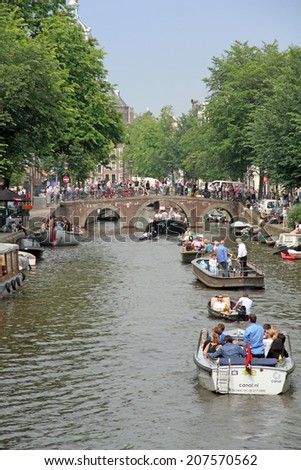 AMSTERDAM HOLLAND-JUNE 7: Amstel canal with boats on Saturday 7 June 2014, in Amsterdam Holland.The Amstel is a river in the Netherlands which runs through the city of Amsterdam.