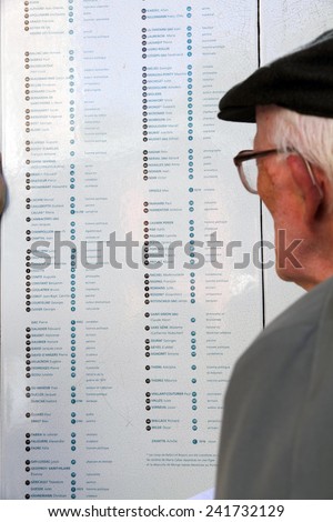 PARIS FRANCE-SEPTEMBER 9: Aged man reading the list of tombs in the Pere Lachaise cemetery on Sept 9, 2012 in Paris.