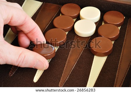 Playing Backgammon, placing a checker (game piece)