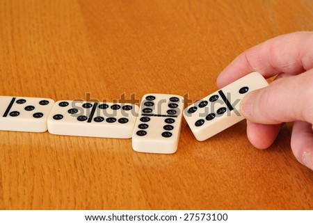 Playing Dominoes on a wood table