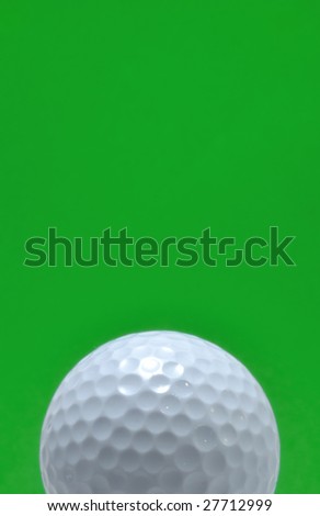 Golf Ball isolated on a green background, copy space, vertical