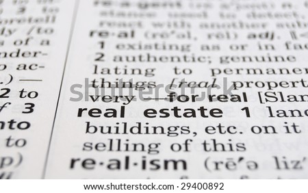 The word Real Estate in a dictionary, closeup
