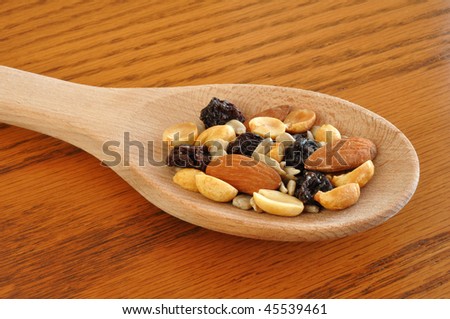 Trail Mix (Peanuts, Almonds, Sunflower Seeds, &  Raisins) on Wooden Spoon