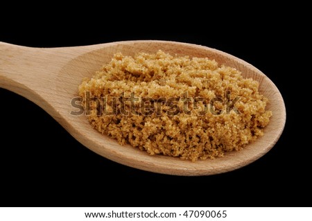 Brown Sugar on a Wooden Spoon Isolated on Black