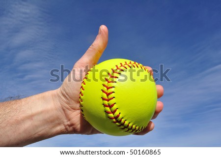 Softball Player Giving Thumbs Up Sign Against a Blue Sky
