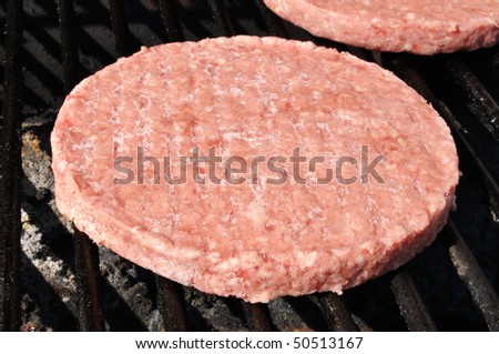 Frozen Hamburger Patties Cooking on the Grill