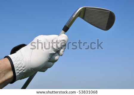 Golfer Wearing a Golf Glove Holding an Iron (Golf Club)