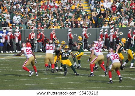 GREEN BAY, WI - NOVEMBER 22 : Green Bay Packers quarterback Aaron Rodgers drops back to pass in a game at Lambeau Field against the San Francisco 49ers on November 22, 2009 in Green Bay, WI
