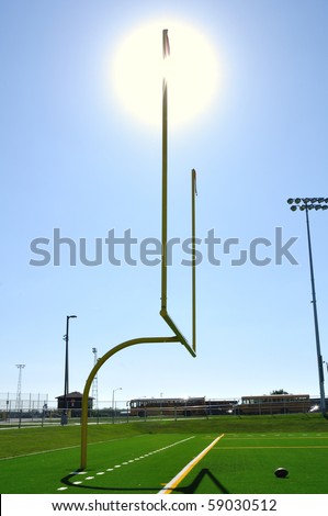 Sun Behind Goal Posts on American Football Field