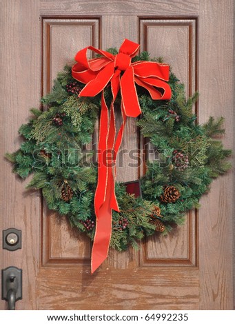 Christmas Wreath with Red Bow on a Door