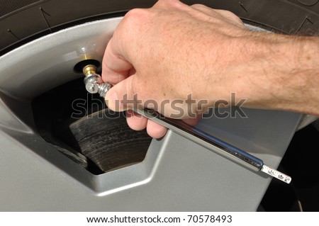 Checking the Air Pressure of a Tire with a Tire-Pressure Gauge