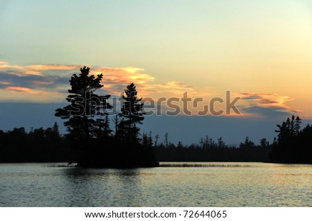 Small Island at Sunset on a Remote Wilderness Lakee with Silhouette of Pine Trees