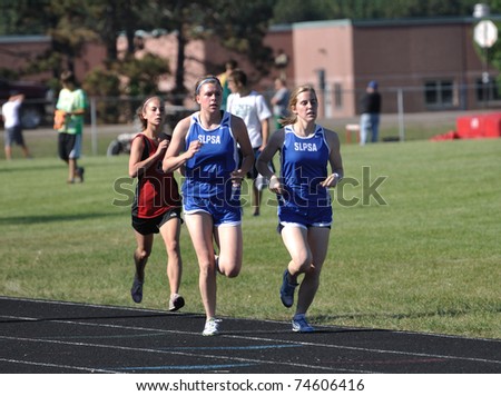 NORTH BRANCH, MN - MAY 27: Unidentified Teen Girls Competing in Long Distance High School Track Meet Race on May 27, 2010 in North Branch, Minnesota.