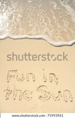 The Words Fun in the Sun Written in the Sand on a Beach