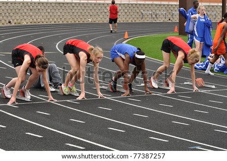 SPRING LAKE PARK, MN - May 7: Unidentified Teen Girls in the Starting Blocks at a High School Sprint Race on May 7, 2010 in Spring Lake Park, Minnesota.