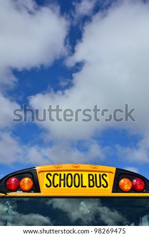 Yellow School Bus with Blue Sky and Clouds