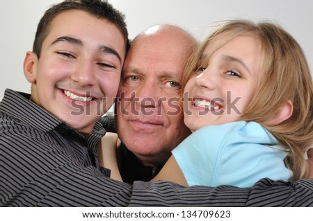 happy family portrait of elderly father with his daughter and son
