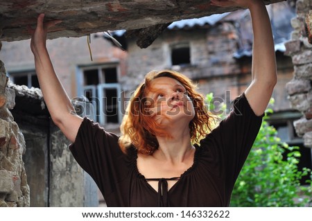 grunge portrait of a  middle age red hair woman in urban ruins