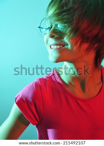 adorable cute happy smiling child wearing eyeglasses  lit with color light