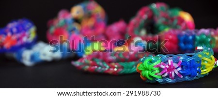 colorful background rainbow colors rubber bands loom bracelets on black background